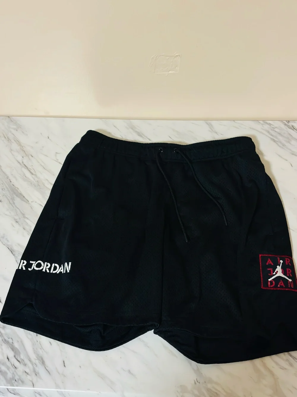 Jordan Black Athletic Mesh Shorts with Red Logo Accent